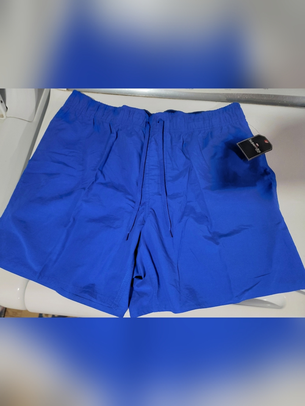 New with tags- Men's St. John's Bay swim shorts. Extreme Blue color.  Large